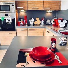 a kitchen with mickey mouse plates and utensils