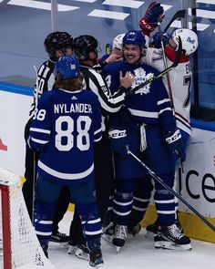 the hockey players are congratulating each other on the ice after their win over the team