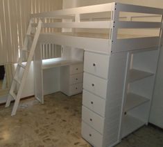 there is a white bunk bed with drawers and a ladder on the bottom shelf next to it