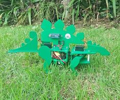 a green machine is sitting in the grass