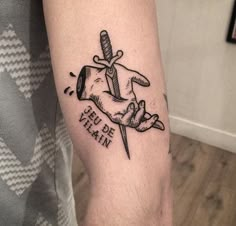 a tattoo on the arm of a man with a knife in it's hand