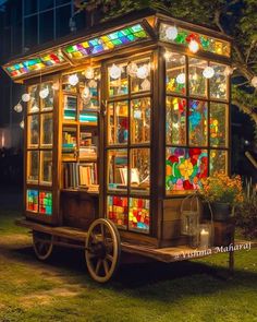 an old - fashioned library cart is decorated with stained glass windows and colorful lights on wheels