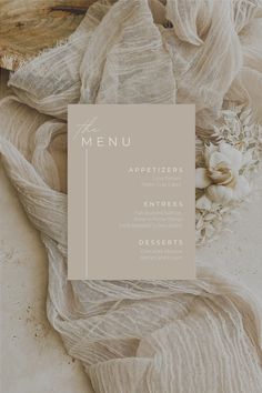 the menu for an event with white flowers