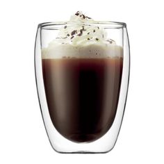 a glass filled with liquid and topped with whipped cream, chocolate sprinkles