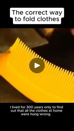 a yellow comb with the words, the correct way to fold clothes i lived for 350 years only to find out that all the clothes at home were hung wrong