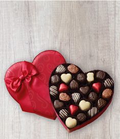 two heart shaped boxes filled with assorted chocolates