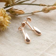 These fantastically futuristic Rose Gold Plated Sterling Silver Two Way Teardrop Stud Earrings are perfect for lovers of contemporary design These stunning sterling silver earrings add glitz and glamour to any outfit or occasion. Their design features a simple teardrop suspended on a rod which hangs behind the ear. There is a further, smaller teardrop which fits on the from of the ear.  Made from: Sterling silver Dimensions: Large teardrop 1.1cm x 0.5cm, small teardrop 0.6cm x 0.3cm. Length 2.4cm Glitz And Glamour, Knot Studs, Heart Locket Necklace, Climber Earrings, Dangly Earrings, Pearl Gemstone, Rose Earrings, Rose Gold Earrings, For Lovers