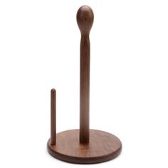 a wooden object with a long stick sticking out of it's center piece, on a white background