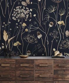 an image of a wallpaper with flowers and plants on the sideboard in front of it