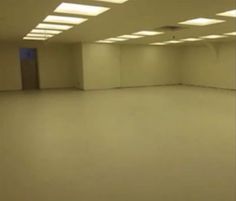 an empty room with lights on the ceiling and no people in it or someone else