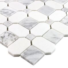 a white marble mosaic tile with hexagonal tiles on the bottom and one side