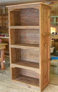 a wooden bookcase sitting on top of a hard wood floor