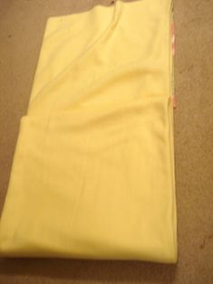 a pair of yellow pants laying on the floor