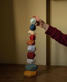 a young boy is playing with wooden blocks