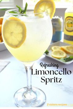 a glass filled with lemonade sitting on top of a table