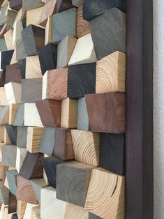 wood pieces are arranged on the wall to make a unique art piece for someone's room