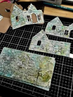 paper cut out houses sitting on top of a table