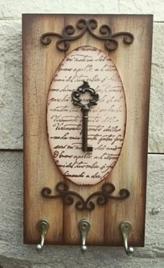 a wooden plaque with a key on it