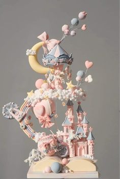 a cake that is made to look like a castle with balloons and stars on it