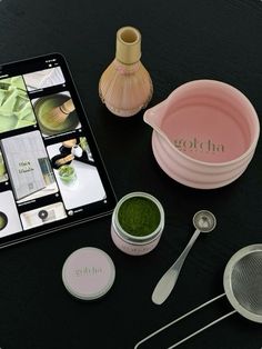 a table with various items on it including spoons, measuring cups and an ipad