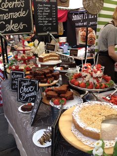 a table filled with lots of different types of cakes and desserts on it's sides