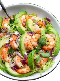 a salad with shrimp, avocado and cilantro in a white bowl