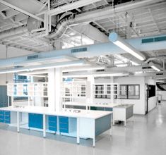 an empty office with blue and white cabinets