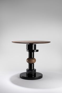 a round table with two wooden pieces on it's legs and an oval top