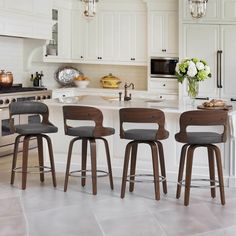 four stools in front of a kitchen island