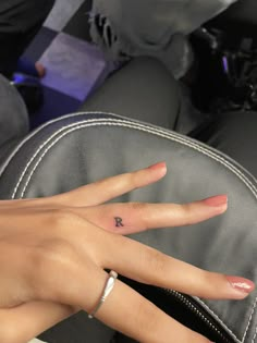 a woman's hand with a small tattoo on it