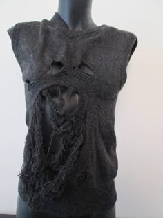 This unique piece of clothes is a second hand vest sweater that has been 'de-knitted' at some parts and re-knitted differently by hand, in a 'grungy-destroyed' way, using ancient artisanal techniques of repairment. It is size 36 FR and also convenient for a 34 FR and a 38 FR. It is pure lambswool, mottled dark grey color. Knitted Crew Neck Vest, Knit Sweater Vest With Crew Neck For Fall, Crew Neck Knit Sweater Vest For Fall, Fall Crew Neck Knit Sweater Vest, Fitted Grunge Vest For Fall, Knit Crew Neck Sweater Vest, Destroyed Sweater, Sleeveless Sweaters, Goth Princess