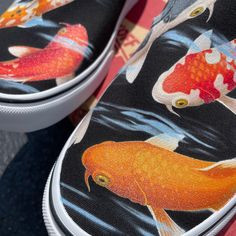 a pair of shoes with fish painted on them