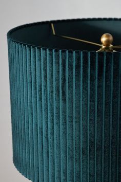 a green lamp shade with gold details on it