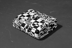 a black and white checkered blanket sitting on top of a floor