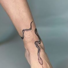 a woman's foot with a tattoo on it and a feather in the middle