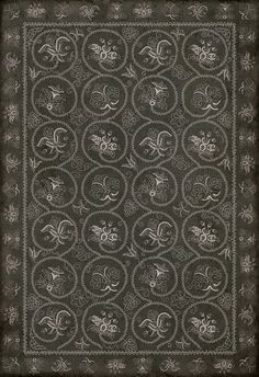 an old black and white photo of a square scarf with floral designs on the border