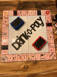 a monopoly board game sitting on top of a wooden table