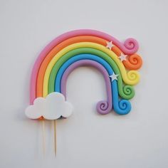 a rainbow cake topper on a white background