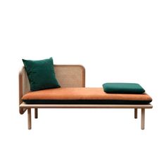 an orange and green daybed with pillows on the top, against a white background