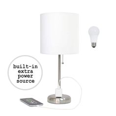 a white lamp sitting on top of a table next to a cell phone