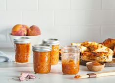 several jars filled with food sitting on top of a counter next to other foods and utensils