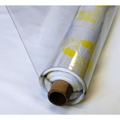 a rolled up piece of paper on top of a white tablecloth with yellow designs