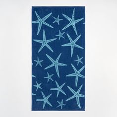 a blue towel with starfishs on it is hanging from the ceiling in front of a white wall