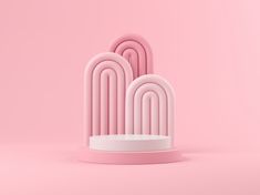 three pink sculptures on a light pink background