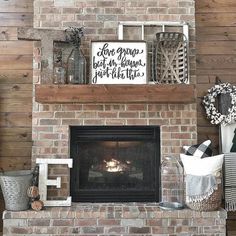 a brick fireplace with a sign above it and other items on the mantels