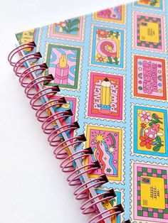 a spiral notebook with colorful images on it