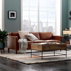 a living room filled with furniture and a large window covered in cityscape behind it