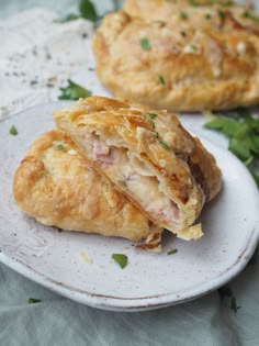 two pastries on a white plate with parsley