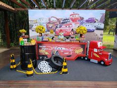 cars and trucks are on display in front of a sign that says, disney pixars