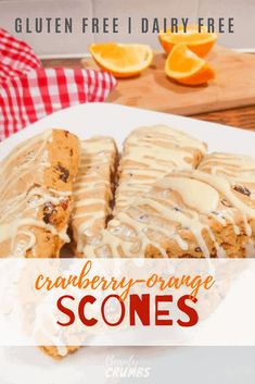 cranberry orange scones on a white plate with drizzled icing